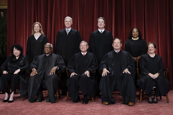 FILE - Members of the Supreme Court sit for a new group portrait following the addition of Associate Justice Ketanji Brown Jackson, at the Supreme Court building in Washington, Oct. 7, 2022. Bottom row, from left, Associate Justice Sonia Sotomayor, Associate Justice Clarence Thomas, Chief Justice of the United States John Roberts, Associate Justice Samuel Alito, and Associate Justice Elena Kagan. Top row, from left, Associate Justice Amy Coney Barrett, Associate Justice Neil Gorsuch, Associate Justice Brett Kavanaugh, and Associate Justice Ketanji Brown Jackson. (AP Photo/J. Scott Applewhite, file)