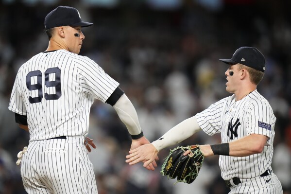 New York Yankees' Aaron Judge, left, celebrates with Harrison Bader after the team's 4-3 win in a baseball game against the Houston Astros on Thursday, Aug. 3, 2023, in New York. (AP Photo/Frank Franklin II)