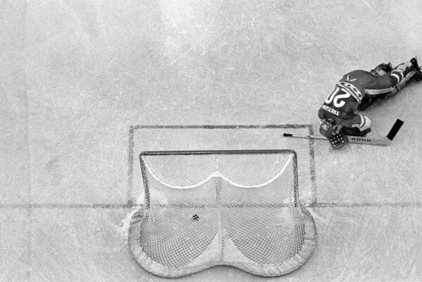 In this Feb. 22, 1980, file photo, Soviet Union hockey goalie Vladislav Tretiak falls to the ice as a goal is scored by U.S. player Mark Johnson (not shown) in the first period of a medal round match at the 1980 Winter Olympics in Lake Placid, N.Y. The U.S. defeated the Soviets 4-3.  (AP Photo/Harry Cabluck, File)