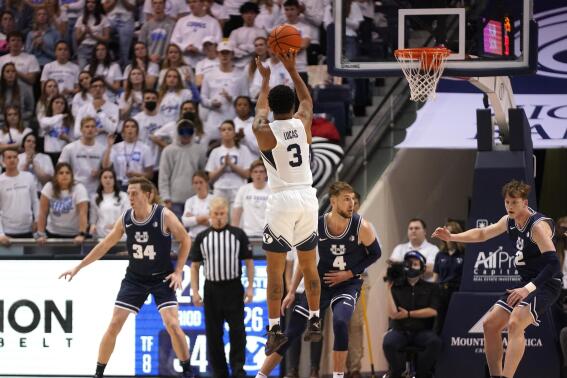 BYU guard Te'Jon Lucas (3) shoots against Utah State in the first half during an NCAA college basketball game Wednesday, Dec. 8, 2021, in Provo, Utah. (AP Photo/Rick Bowmer)