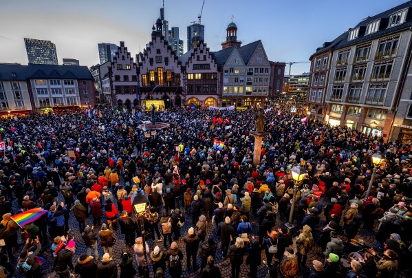 FILE - People gather in front of the town hall to attend the rally "Frankfurt stands up for democracy" against the AfD and right wing extremism in Frankfurt, Germany, Feb. 5, 2024. Millions of Germans have been protesting against the rise of the far-right in huge rallies all over the country for weeks in a row, attending events with slogans such as "Never Again is Now." The protesters have been alarmed by the growing popularity and policies of the far-right Alternative for Germany, or AfD party.(AP Photo/Michael Probst, File)