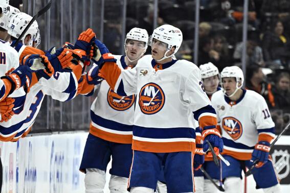 New York Islanders right wing Hudson Fasching (20) is congratulated after scoring against the Anaheim Ducks during the second period of an NHL hockey game in Anaheim, Calif., Wednesday, March 15, 2023. (AP Photo/Alex Gallardo)