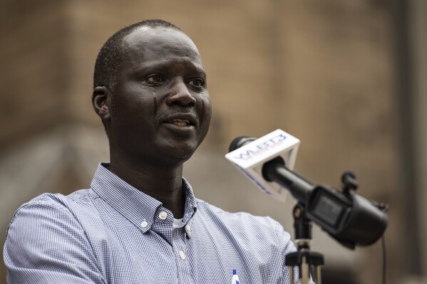 Bul Mabil has tears streaming down his face as he speaks during a press conference to ask for the public's help in finding his brother, Dau Mabil, at St. Andrew's Episcopal Cathedral in Jackson Miss., on Monday, April 1, 2024. As a child, Dau Mabil escaped war-torn Sudan and built a new life in Mississippi. In April, fishermen found his body floating in a river in the state — prompting calls for a federal investigation into his disappearance and death. (Lauren Witte/The Clarion-Ledger via AP)