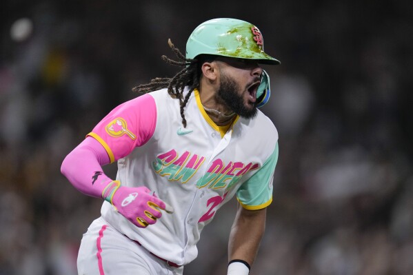 San Diego Padres' Fernando Tatis Jr. celebrates as he rounds the bases after hitting a two-run home run during the eighth inning of a baseball game against the Arizona Diamondbacks, Friday, Aug. 18, 2023, in San Diego. (AP Photo/Gregory Bull)