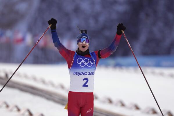 Johannes Thingnes Boe of Norway crosses the finish line in the men's 15-kilometer mass start biathlon at the 2022 Winter Olympics, Friday, Feb. 18, 2022, in Zhangjiakou, China. (AP Photo/Kirsty Wigglesworth)
