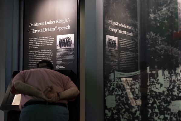 A visitor looks closely at the original copy of the Rev. Martin Luther King Jr.'s "I Have a Dream" speech on display at the National Museum of African American History and Culture in Washington, Friday, Aug. 18, 2023. (AP Photo/Stephanie Scarbrough)