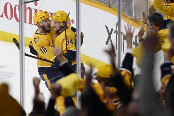 Nashville Predators' Tanner Jeannot (84) is congratulated by Colton Sissons (10) after Jeannot scored the winning goal against the Philadelphia Flyers in the third period of an NHL hockey game Sunday, March 27, 2022, in Nashville, Tenn. The Predators won 5-4. (AP Photo/Mark Zaleski)