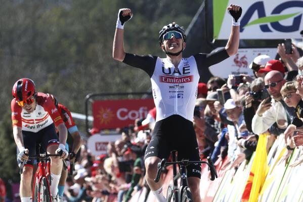 Slovenia's Tadej Pogacar of the UAE Team Emirates crosses the finish line to win the Belgian cycling classic and UCI World Tour race Fleche Wallonne (Walloon Arrow), in Huy, Belgium, Wednesday, April 19, 2023. (AP Photo/Geert Vanden Wijngaert)