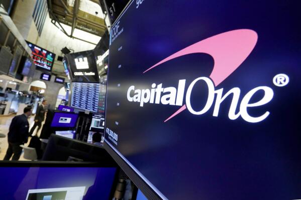 FILE - The logo for Capital One Financial is displayed above a trading post on the floor of the New York Stock Exchange, July 30, 2019. A federal jury on Friday, June 17, 2022, convicted a former Seattle tech worker of several charges related to a massive hack of Capital One bank and other companies in 2019. (AP Photo/Richard Drew, File)