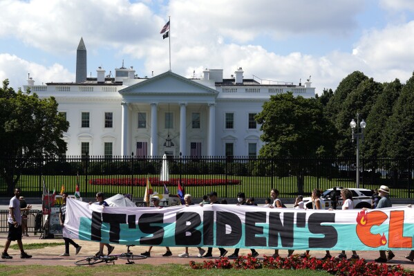 FILE - Climate activists rally in front of the White House at Lafayette Square to demand that President Joe Biden declare a climate emergency and move the country rapidly away from fossil fuels, July 4, 2023, in Washington. After being thwarted by Congress, Biden will use his executive authority to create a New Deal-style American Climate Corps that will serve as a major green jobs training program. (AP Photo/Yuri Gripas, File)