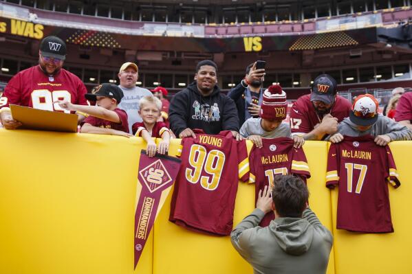 Washington Commanders quarterback Sam Howell (14) signs memorabilia for fans before a NFL football game between the Washington Commanders and the Minnesota Vikings on Sunday, Nov. 6, 2022 in Landover, Md. (Shaban Athuman/Richmond Times-Dispatch via AP)