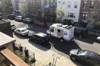 In this April 14, 2020, photo, an ice cream truck moves down the street in the Queens borough of New York. (AP Photo/Sophie Rosenbaum)