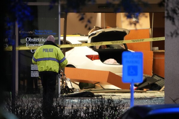 Police investigate after a car crashed into an emergency room at St. David's North Austin Medical Center Medical Center, Tuesday, Feb. 13, 2024, in Austin. (Jay Janner/Austin American-Statesman via AP)