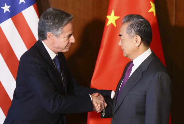 U.S. Secretary of State Antony Blinken, left, and Chinese Foreign Minister Wang Yi shake hands during their meeting at the Munich Security Conference, in Munich, Germany, Friday, Feb. 16, 2024. (Wolfgang Rattay/Pool Photo via AP)