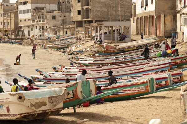 Children play on fishing boats known as “pirogues” in Dakar, Senegal, Saturday June 24, 2023. Large pirogues such as the one found Tuesday, Aug. 15, 2023, near Cabo Verde are used in migrant crossings from Senegal to Spain. (AP Photo/Zane Irwin)
