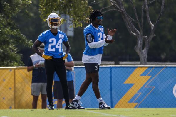 Los Angeles Chargers safeties Derwin James Jr. right, applauds next to Nasir Adderley (24) during the NFL football team's training camp Wednesday, July 27, 2022, in Costa Mesa, Calif. (AP Photo/Ringo H.W. Chiu)
