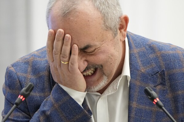 Boris Nadezhdin, a liberal Russian politician who is seeking to run in the March 17 presidential election, laughs during a meeting of the Russia's Central Election Commission in Moscow, Russia, Thursday, Feb. 8, 2024. Russia's Central Election Commission holds a meeting where it decides whether an opposition presidential candidate Boris Nadezhdin is qualified to run in the March election. (AP Photo/Alexander Zemlianichenko)