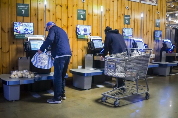 Customers use self-checkout kiosks at Stew Leonard's grocery store in Paramus, N.J., Wednesday, Dec. 13, 2023, in New York. Self-checkout faces a reckoning of sorts just as retailers are in the midst of their busiest time of the year. (AP Photo/Bebeto Matthews)