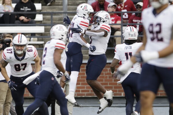 Arizona running back Rayshon Luke, center left, celebrates his touchdown against Washington State with running back Jonah Coleman during the first half of an NCAA college football game Saturday, Oct. 14, 2023, in Pullman, Wash. (AP Photo/Young Kwak)