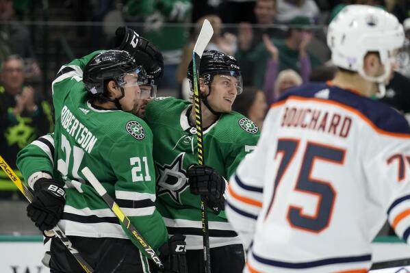 Dallas Stars' Jason Robertson (21), Alexander Radulov, second from left, and Roope Hintz, center celebrate a goal scored by Hintz as Edmonton Oilers' Evan Bouchard (75) skates psst in the first period of an NHL hockey game in Dallas, Tuesday, Nov. 23, 2021. (AP Photo/Tony Gutierrez)