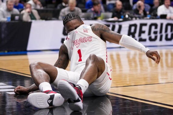 Houston's Jamal Shead reacts after going down while driving to the basket against Duke during the first half of a Sweet 16 college basketball game in the NCAA Tournament in Dallas, Friday, March 29, 2024. (AP Photo/Tony Gutierrez)