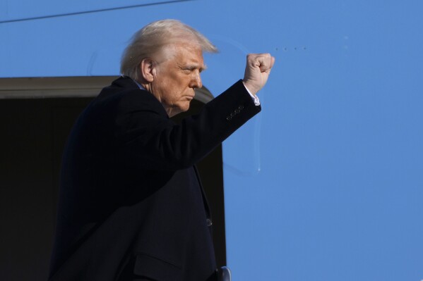 President Donald Trump gestures as he boards Air Force One at Joint Base Andrews, Md., Friday, Feb. 14, 2025, en route to West Palm Beach, Fla. (AP Photo/Ben Curtis)