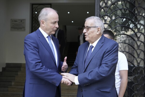Lebanese Foreign Minister Abdallah Bouhabib, right, shakes hands with Ireland's Deputy Prime Minister and Foreign Minister Micheal Martin after their meeting in Beirut, Lebanon, Monday, May 20, 2024. (AP Photo/Hassan Ammar)