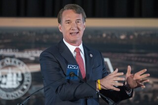FILE - Virginia Gov. Glenn Youngkin speaks Dec. 13, 2023, at an event in Alexandria, Va. Gov. Youngkin proposed a new state budget Wednesday, Dec. 20, that would lower income taxes and raise the state's sales tax to allow Virginians “to keep more of their hard-earned money.” (AP Photo/Alex Brandon, File)