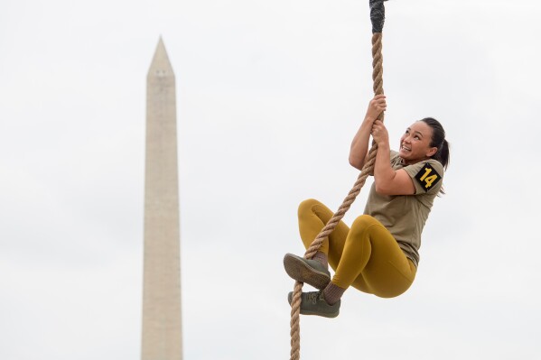 A team member competes in the rope climb portion of the Army fitness competition during the festival event to honor the Army's 250th anniversary, coinciding with President Donald Trump's 79th birthday, Saturday, June 14, 2025, on the National Mall in Washington. (AP Photo/Rod Lamkey, Jr.)
