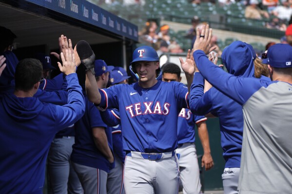 Texas Rangers' Corey Seager celebrates scoring against the Detroit Tigers in the sixth inning of a baseball game, Wednesday, April 17, 2024, in Detroit. (AP Photo/Paul Sancya)