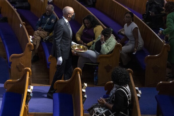 A donation plate is passed during Palm Sunday services at the Metropolitan AME Church in Washington, Sunday, March 24, 2024. As Black Protestants prepare for Easter this year, they hope to welcome more people to church than since the COVID-19 pandemic began four years ago. (AP Photo/Amanda Andrade-Rhoades)