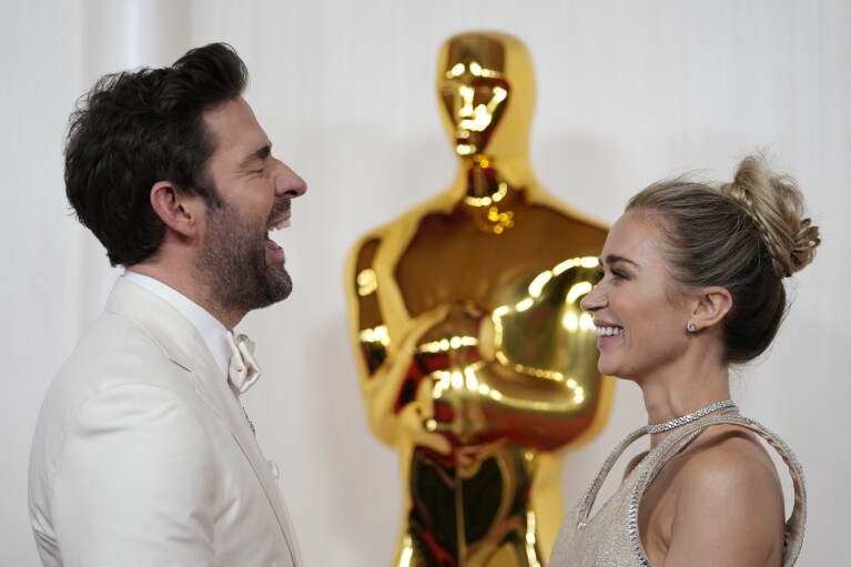 John Krasinski, left, and Emily Blunt arrive at the Oscars on Sunday, March 10, 2024, at the Dolby Theatre in Los Angeles. (AP Photo/Ashley Landis)
