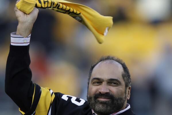 FILE - Pittsburgh Steelers Hall of Fame running back Franco Harris twirls a Terrible Towel during a ceremony commemorating the 40th anniversary of his "Immaculate Reception" catch in the 1972 playoff game against the Oakland Raiders, during the halftime of an NFL football game between the Steelers and the Cincinnati Bengals in Pittsburgh, Sunday, Dec. 23, 2012. Franco Harris, the Hall of Fame running back whose heads-up thinking authored “The Immaculate Reception,” considered the most iconic play in NFL history, died Wednesday, Dec. 21, 2022. He was 72. (AP Photo/Gene J. Puskar, File)