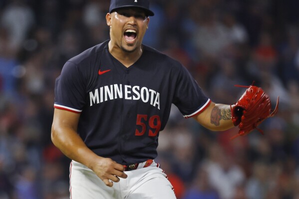 Minnesota Twins relief pitcher Jhoan Duran celebrates after a win over the Chicago White Sox in a baseball game Saturday, July 22, 2023, in Minneapolis. (AP Photo/Bruce Kluckhohn)