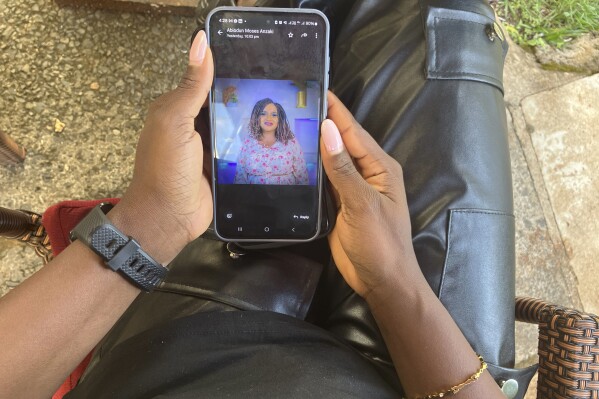 A Kenya-based content moderator views in Nairobi, Kenya, Tuesday, March 11, 2025, a photo of a former colleague, Ladi Anzaki Olubunm, who died in unclear circumstances (AP Photo/Evelyne Musambi)