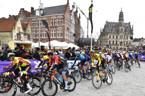 FILE - France's Christophe Laporte of the Jumbo Visma team, center, competes during the Tour of Flanders in Oudenaarde, Belgium on Sunday, April 2, 2023. Polish cyclist Filip Maciejuk will serve a 30-day ban for causing a mass crash with a dangerous move at the Tour of Flanders in April. The International Cycling Union announced the ban Wednesday, July 26, 2023, one day after it took effect. The 23-year-old Polish rider for the Bahrain Victorious team will sit out races including the Tour of Poland and the world championships starting next week in Scotland. (AP Photo/Geert Vanden Wijngaert, File)