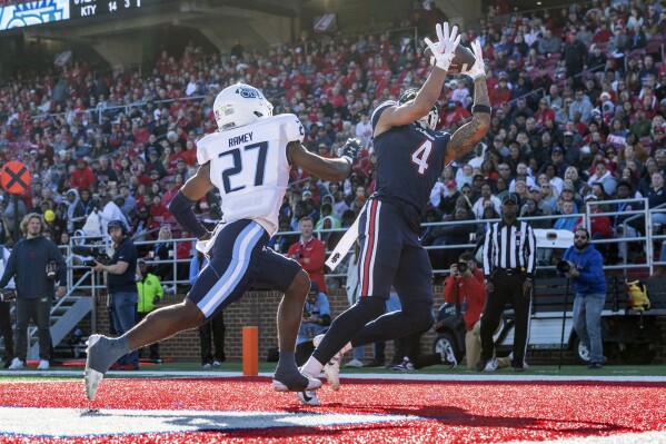 Liberty's CJ Daniels catches a touchdown pass ahead of Old Dominion's Ryan Ramey (27) during the first half of an NCAA college football game, Saturday, Nov. 11, 2023, in Lynchburg, Va. (AP Photo/Robert Simmons)