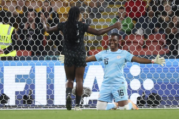 Nigeria's Michelle Alozie, left, celebrate with Nigeria's goalkeeper Chiamaka Nnadozie after playing to a 0-0 draw during the Women's World Cup Group B soccer match between Ireland and Nigeria in Brisbane, Australia, Monday, July 31, 2023. (AP Photo/Katie Tucker)