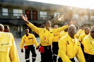 South African firefighters dance during a break in their morning meeting in Fox Creek, Alberta, on Tuesday, July 4, 2023. Several countries, including South Africa, deployed firefighters to Canada to help local efforts to control widespread wildfires. (AP Photo/Noah Berger)