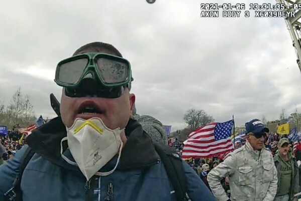 This image from police-worn body cam video contained in the statement of facts to support the arrest of Joseph Padilla, shows Padilla on the West Front of the U.S. Capitol on Jan. 6, 2021, in Washington. Padilla, who wrote on social media about wanting to "take over the Capitol building" before the Jan. 6, 2021 riot, where he threw a flagpole at a police officer's head, has been sentenced to more than six years in prison on Sept. 13, 2023. (Department of Justice via AP)