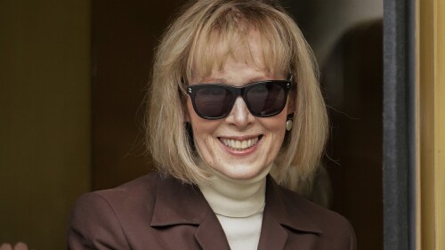 FILE - E. Jean Carroll walks out of federal court in Manhattan, May 9, 2023, in New York. The Justice Department on Tuesday, July 11, 2023, said that former President Donald Trump can be held personally liable for remarks he made about a Carroll, who accused him of rape, a reversal of its position that Trump was protected because he was president when he made the remarks. (AP Photo/John Minchillo, File)
