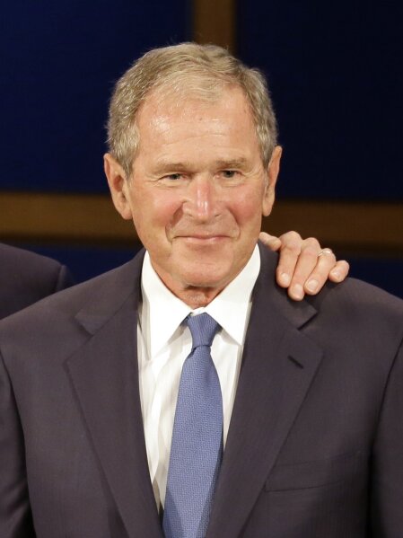 FILE - Former President George W. Bush, appears during a discussion at the Presidential Leadership Scholars graduation ceremony at the George W. Bush Presidential Center in Dallas on July 13, 2017. Bush will honor American immigrants in a book coming out in March. Bush's "Out Of Many, One: Portraits of America's Immigrants" includes 43 portraits by the 43rd president. (AP Photo/Tony Gutierrez, File)