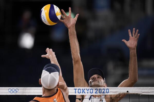 iPhilip Dalhausser, of the United States, blocks against Alexander Brouwer, of the Netherlands, during a men's beach volleyball match at the 2020 Summer Olympics, Saturday, July 24, 2021, in Tokyo, Japan. (AP Photo/Felipe Dana)