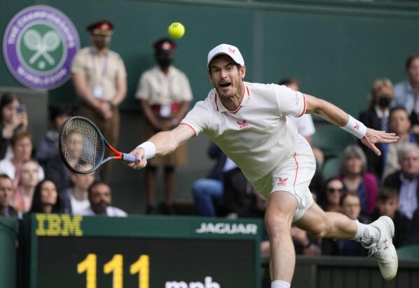 Britain's Andy Murray returns the ball to Georgia's Nikoloz Basilashvili during the men's singles match on day one of the Wimbledon Tennis Championships in London, Monday June 28, 2021. (AP Photo/Kirsty Wigglesworth)