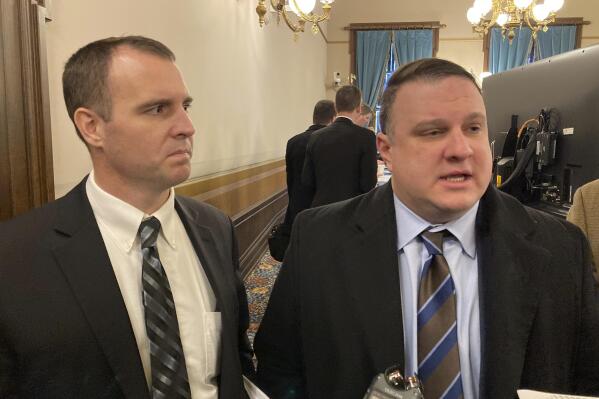 House Appropriations Committee Chair Thomas Albert, R-Lowell, left, and House Tax Policy Committee Chair Matt Hall, R-Marshall, right, speak with reporters on Thursday, Feb. 24, 2022, at the state Capitol in Lansing, Mich. Their committees passed bills that would cut the income tax rate, expand exemptions for seniors and shore up pension funds. (AP Photo/David Eggert)