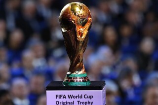 FILE - The original FIFA World Cup trophy is displayed during the 2018 soccer World Cup draw in the Kremlin in Moscow, Dec. 1, 2017. FIFA says it will consider changes to its policy that blocks league matches from being played in other countries as part of an agreement with a soccer promoter to dismiss the world governing body from a lawsuit challenging that policy. (AP Photo/Alexander Zemlianichenko, File)