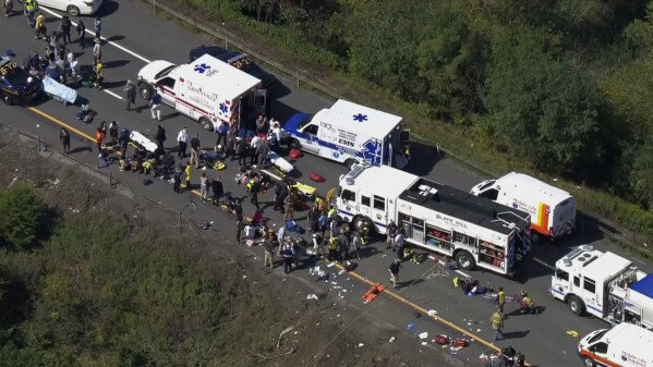 Emergency responders work the scene of a fatal bus crash, in Wawayanda, N.Y., Thursday, Sept. 21, 2023. The charter bus carrying high school students to a band camp hurtled off a New York highway and down an embankment, officials said. (NBC New York via AP)