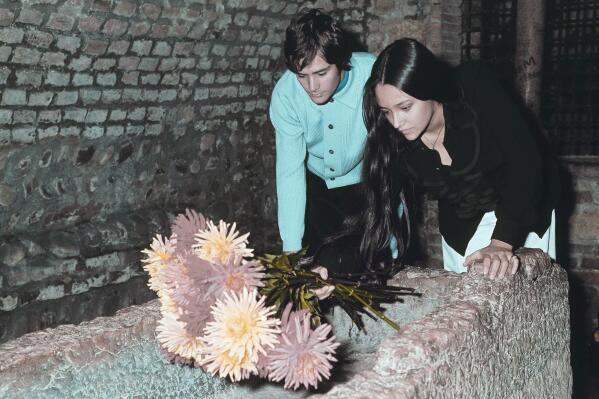 FILE - Olivia Hussey and Leonard Whiting, who are playing the title roles in Franco Zeffirelli's "Romeo and Juliet," place flowers on the "Tomba di Giulietta", or the Tomb of Juliet, in Verona, northern Italy, on Oct. 22, 1968. The two stars of 1968's “Romeo and Juliet” sued Paramount Pictures for more than $500 million on Tuesday, Jan. 3, 2023, over a nude scene in the film shot when they were teens. (AP Photo/File)