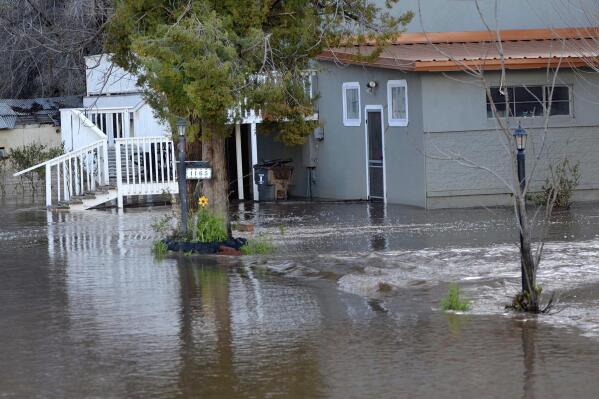 Residents in Cottonwood, Ariz., woke up to a swollen Verde River Wednesday, March 22, 2023 after a Go order was issued during the night to leave their homes by the Yavapai County Sheriff's Office. More rain is expected on Wednesday and Thursday. (Vyto Starinskas/The Daily Courier via AP)