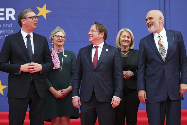 Serbia's President Aleksandar Vucic, left, European Commissioner for Neighbourhood and Enlargement Oliver Varhelyi, center, and Albania's Prime Minister Edi Rama, right, talk during a family photo in Tirana, Albania, Thursday, Feb. 29, 2024. The leaders of Western Balkan countries met Thursday in another joint push to use the European Union's financial support plan of six billion euros (about $6.5 billion) hoping it will speed up its membership in the bloc. (AP Photo/Armando Babani)